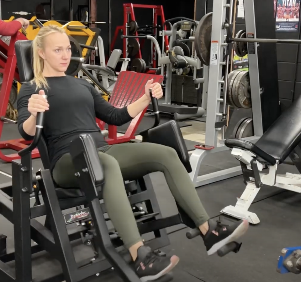 Kathryn Alexander demonstrates the Dynavec Gluteator glute training system at Big Tex Gym in Austin, Texas.