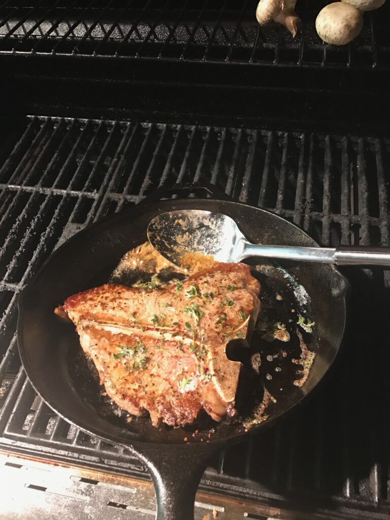 Steak on the grill in the cast iron